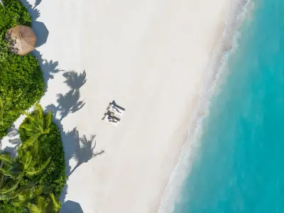 Couple on the Beach Waldorf Astoria Maldives Ithaafushi